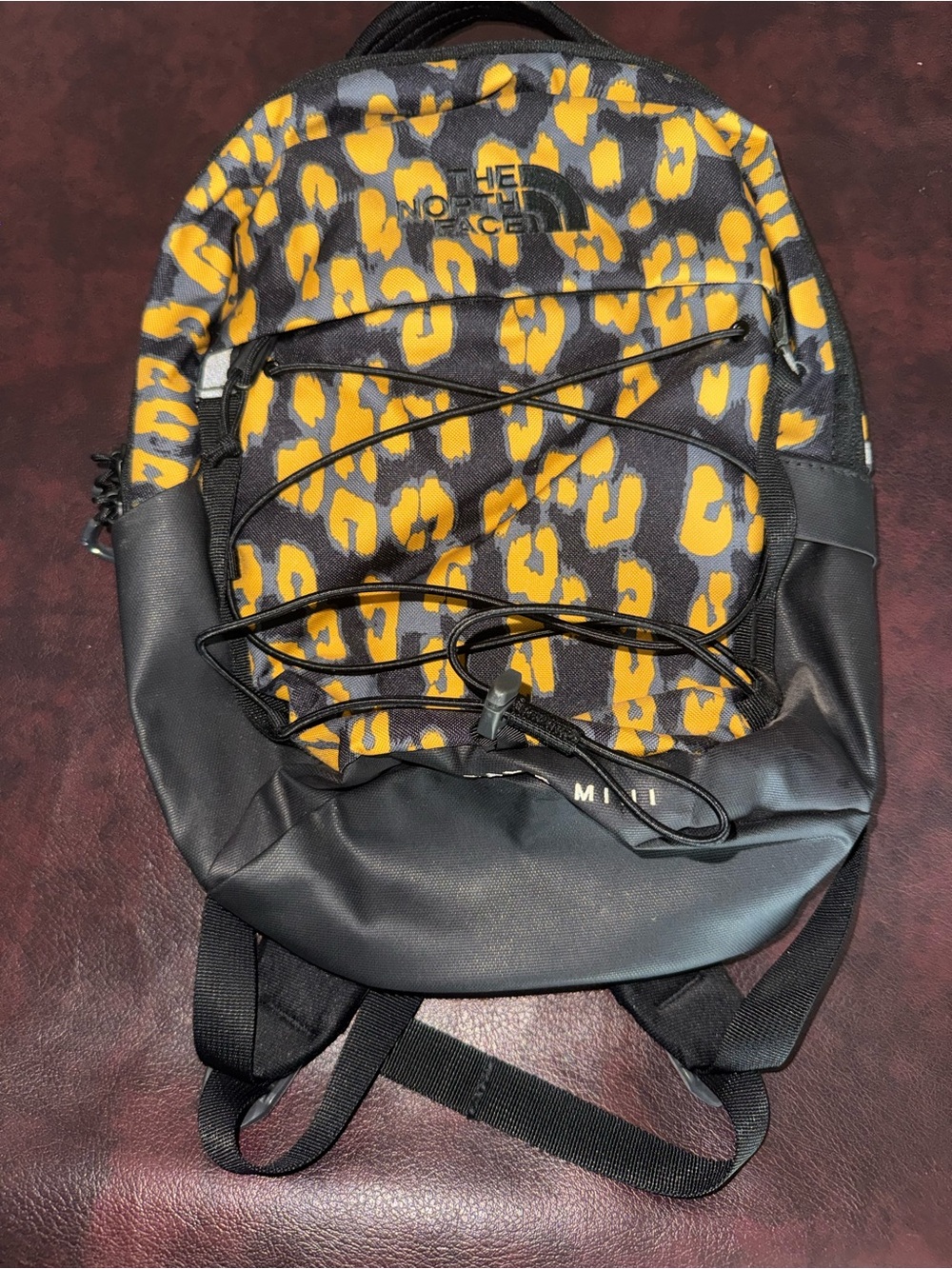 The North Face Black and Yellow Leopard Print Mini Backpack